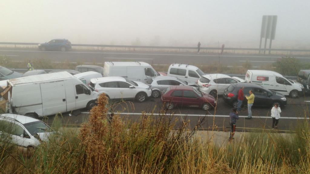 General view of the scene of an accident involving multiple vehicles, caused by heavy fog on a road near Galisteo, Caceres, Extr