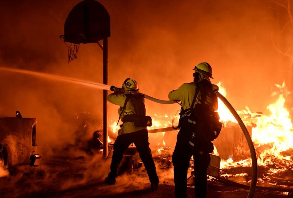 Firefighters battle flames from a Santa Ana wind-driven brush fire called the Thomas Fire in Santa Paula, California