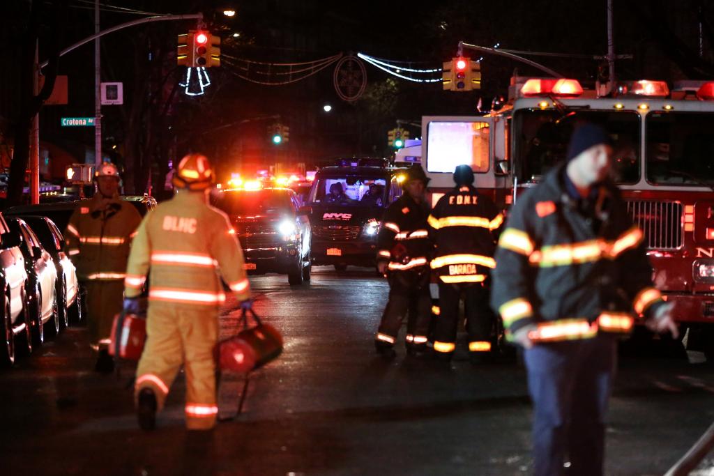 FDNY personnel work on the scene of an apartment fire in New York