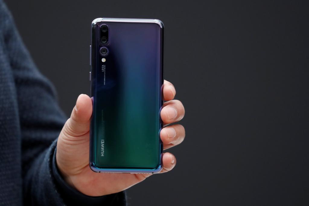 Richard Yu, CEO of the Huawei Consumer Business Group, holds a Huawei P20 smartphone during the launching the new generation of 