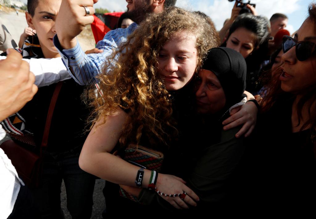 Palestinian teenager Ahed Tamimi is welcomed by relatives and supporters after she was released from an Israeli prison, at Nabi 