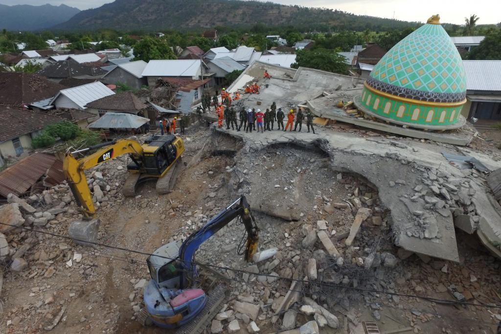 An aerial view of the collapsed Jamiul Jamaah mosque where rescue workers and soldiers search for earthquake victims in Pemenang