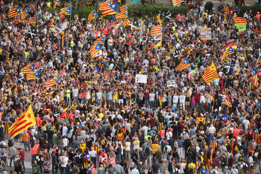 People attend a demonstration on the first anniversary of Catalonia's banned independence referendum in Barcelona