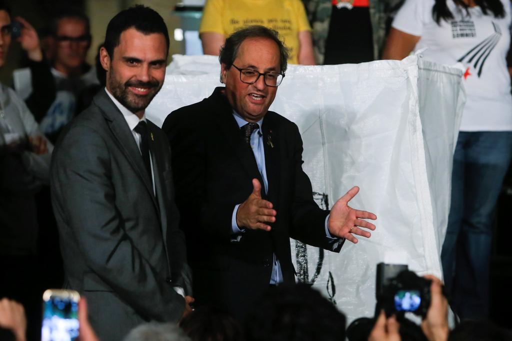 Catalan President Quim Torra and Parliament speaker Roger Torrent react at the end of a demonstration on the first anniversary o